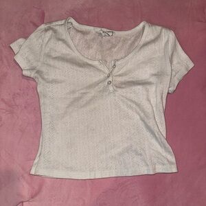 White crop top with coquette heart and ribbed pattern.